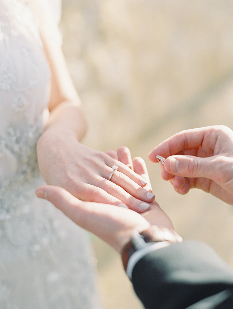 groom putting on bride's ring during the ceremony