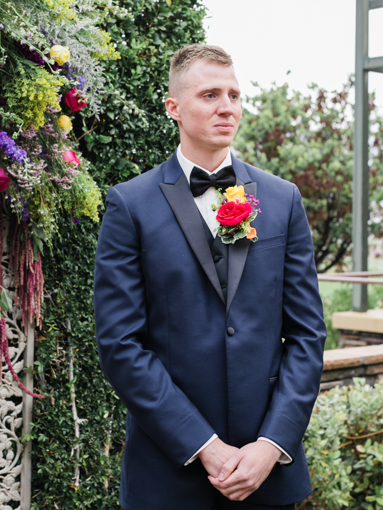 groom's smiling reaction seeing his bride walk down the aisle