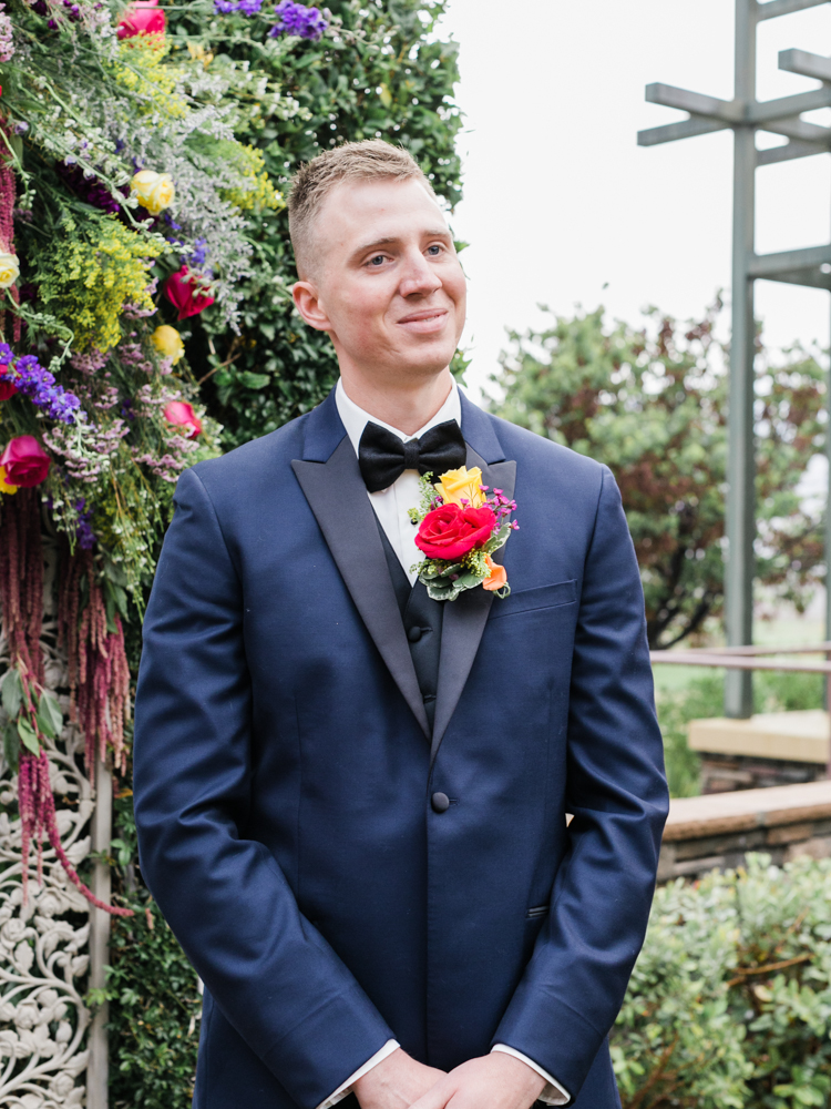 groom's smiling reaction seeing his bride walk down the aisle