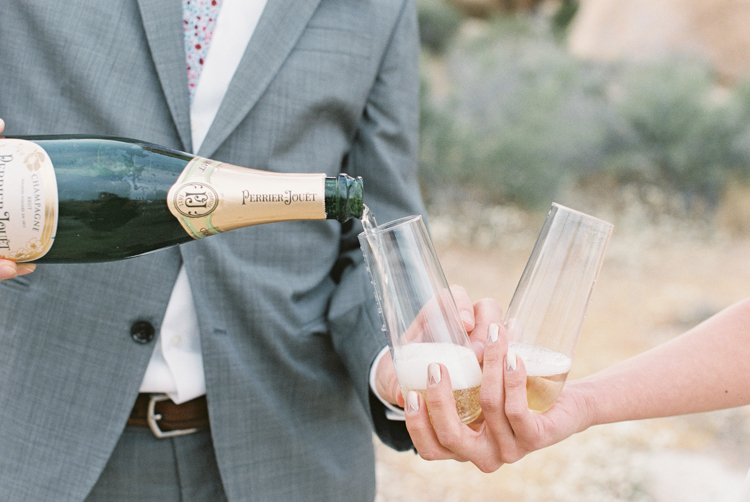 bride and groom drinking champagne after ceremony