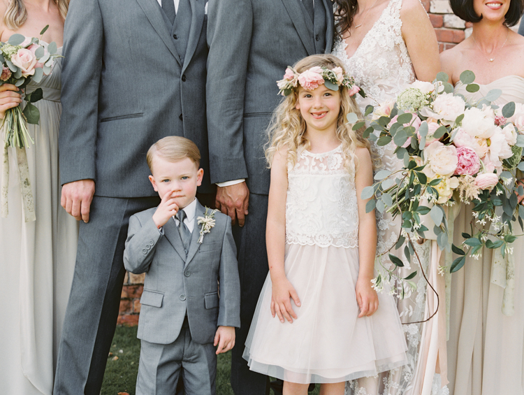 flower girl with flower crown and ring bearer picking nose