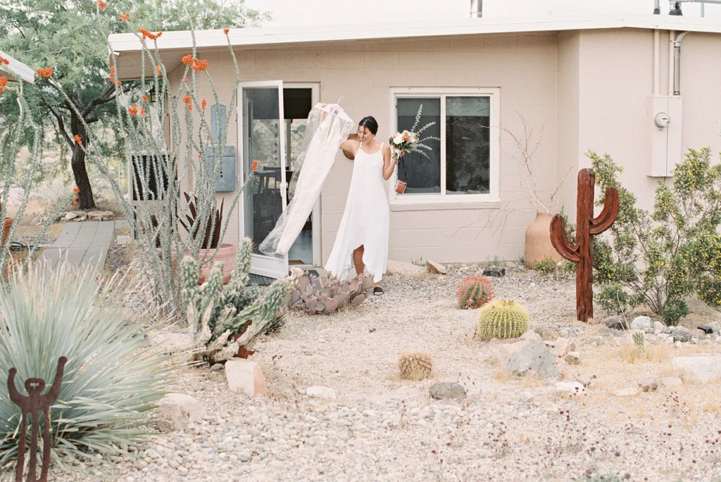 bride holding wedding dress