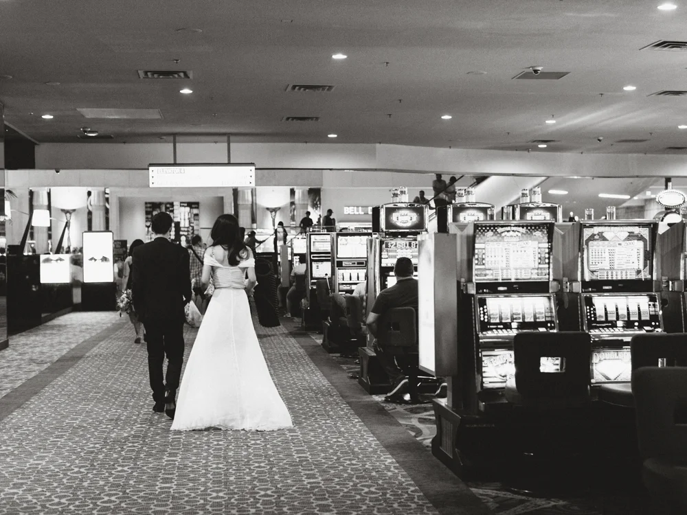 bride and groom walking through casino