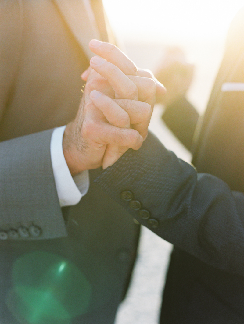 two grooms holding hands