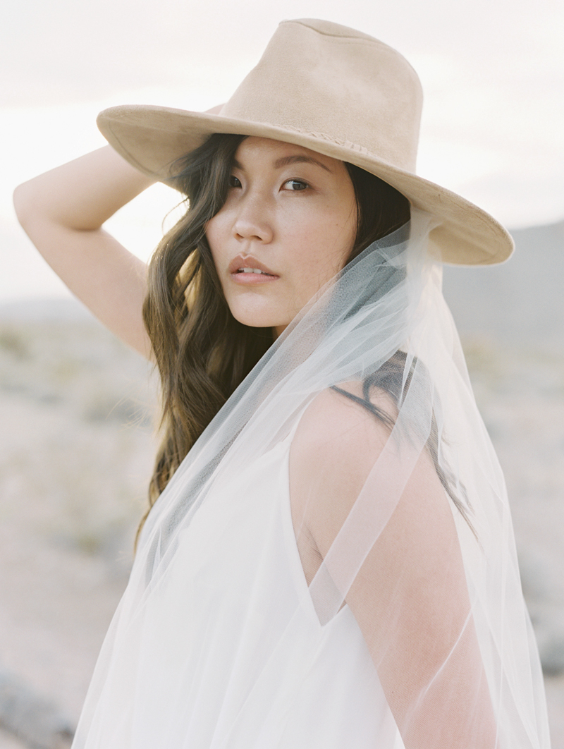 bride wearing cowboy hat and veil