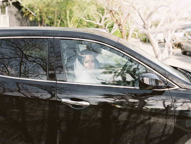 bride driving in car to wedding ceremony