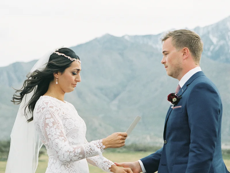 groom comforting his bride during vows