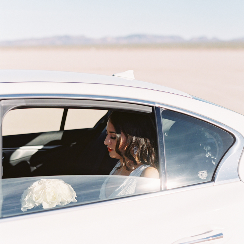 bride in car - dry lake bed wedding