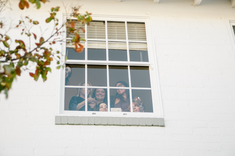 wedding party looking through window