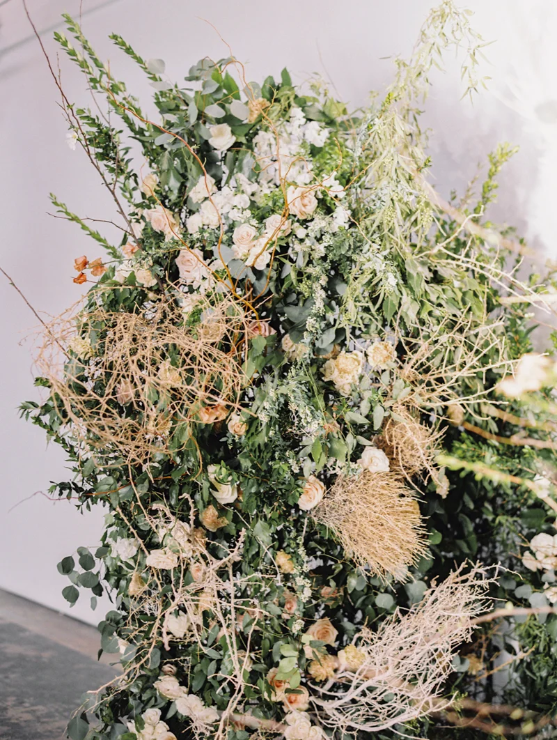 wedding arch with flowers and tumbleweeds