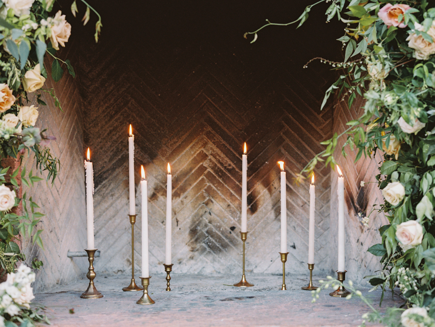 antique candle holders in fireplace for wedding ceremony altar