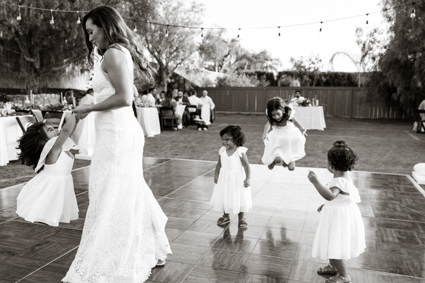 bride dancing with her flower girls