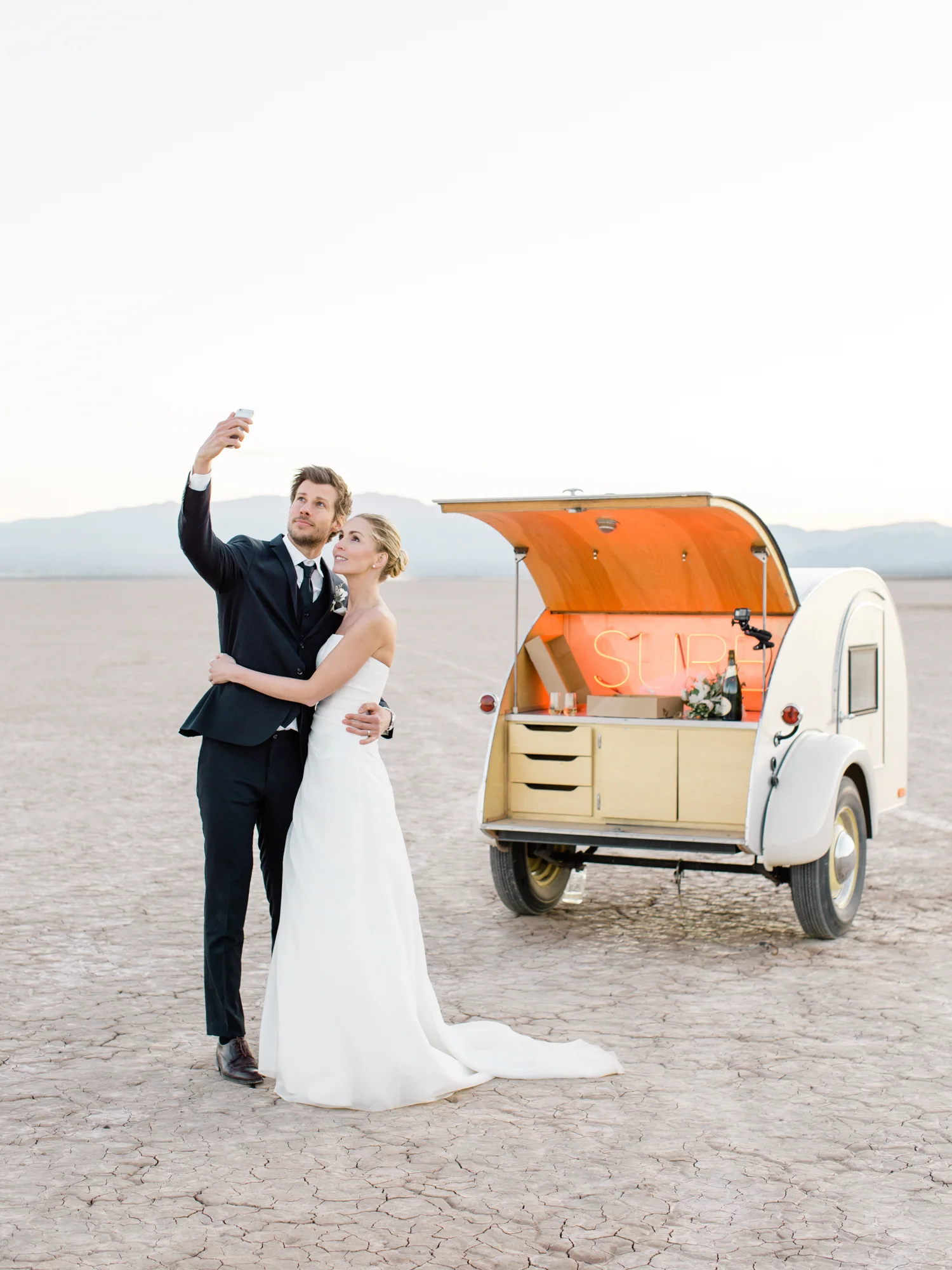 bride and groom taking a selfie flora pop trailer