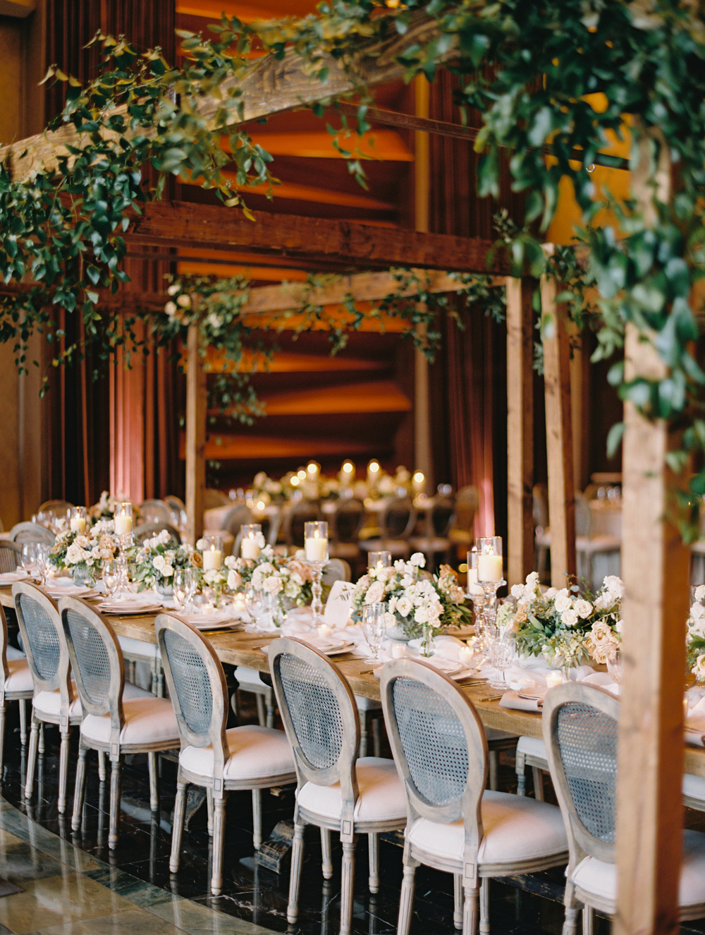 wooden cabanas with greenery wedding reception