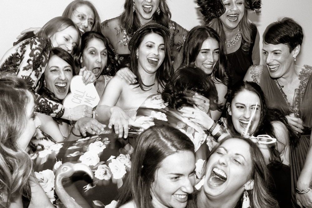 wedding party crashing photobooth having fun