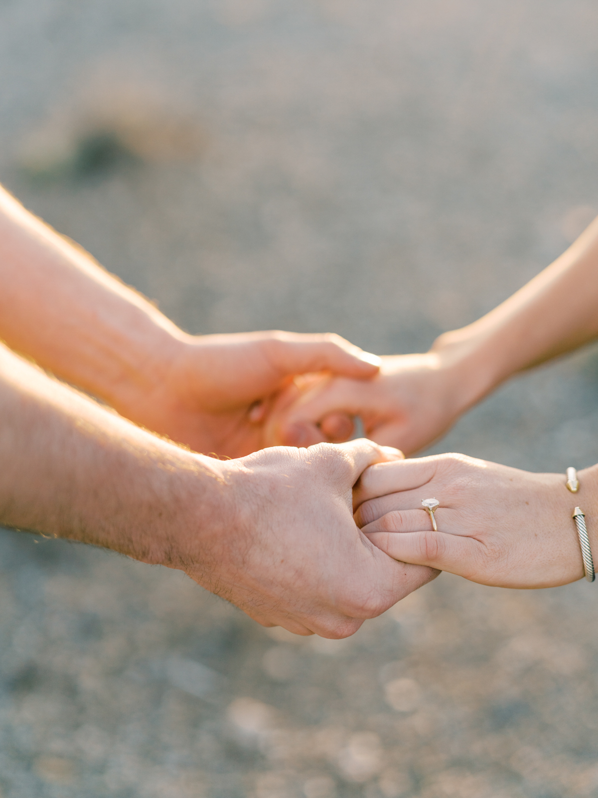 couple holding hands in the desert