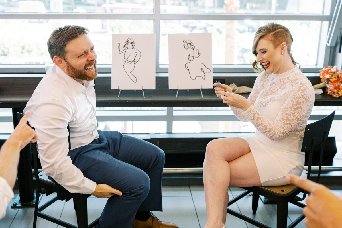 bride and groom drawing each other