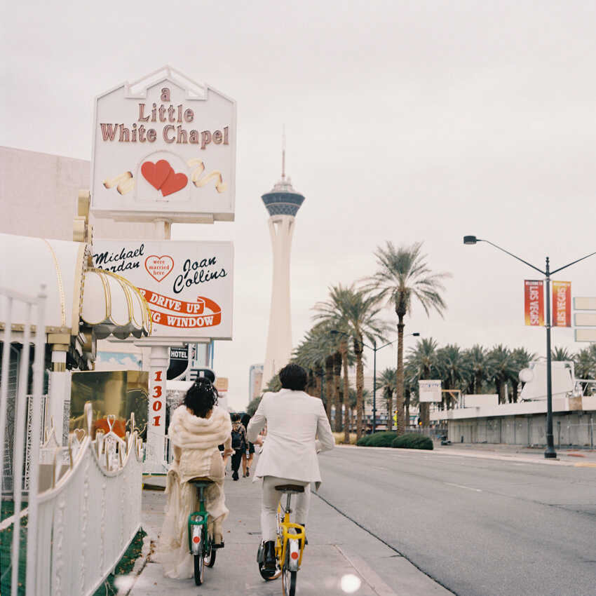 bride and groom riding bikes to the chapel las vegas