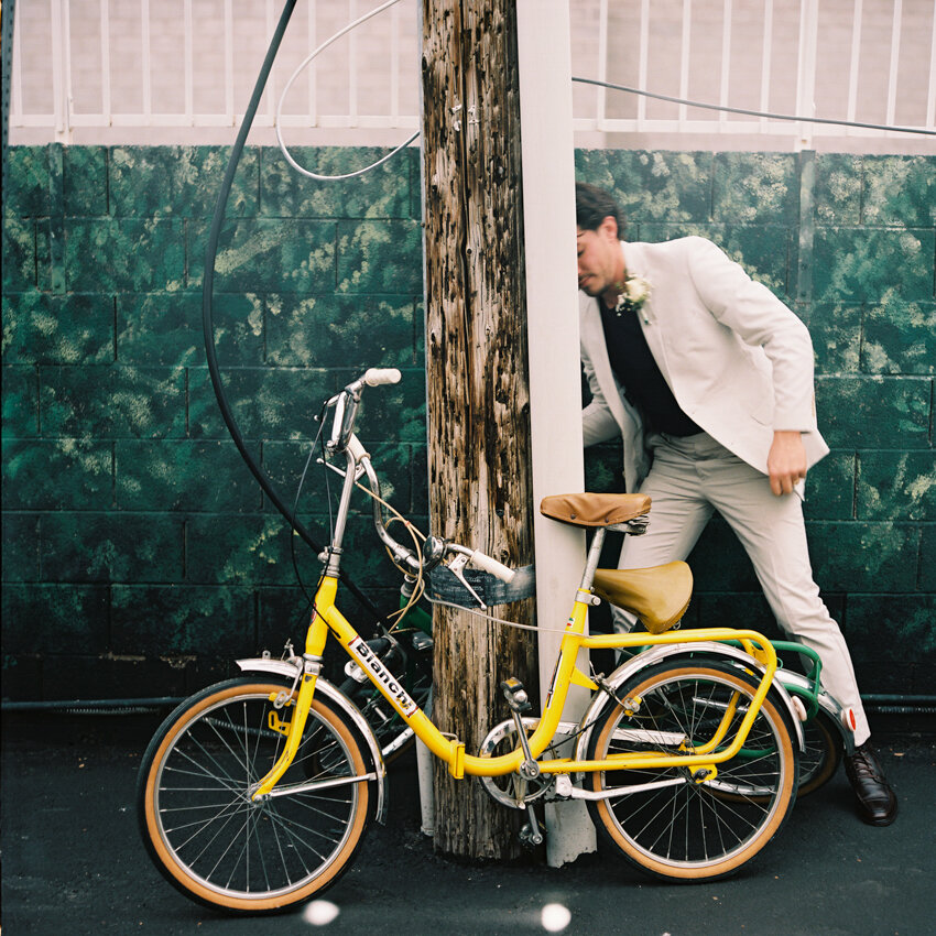 bride and groom riding bikes to the chapel las vegas