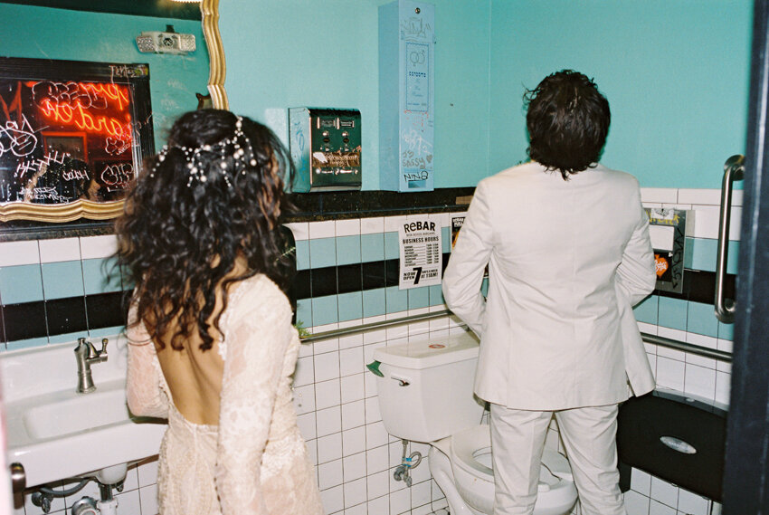 bride catches groom peeing in the stall