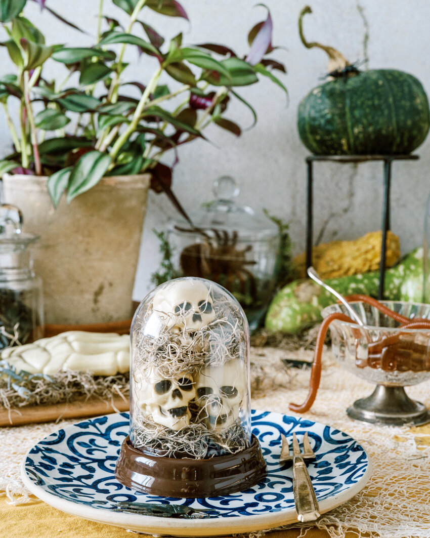 shrunken skulls in a cloche halloween