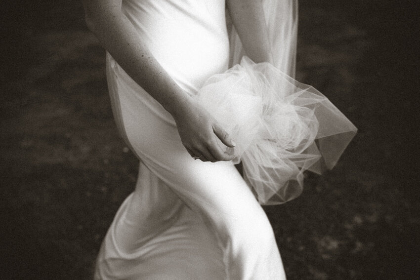 bride holding onto her veil