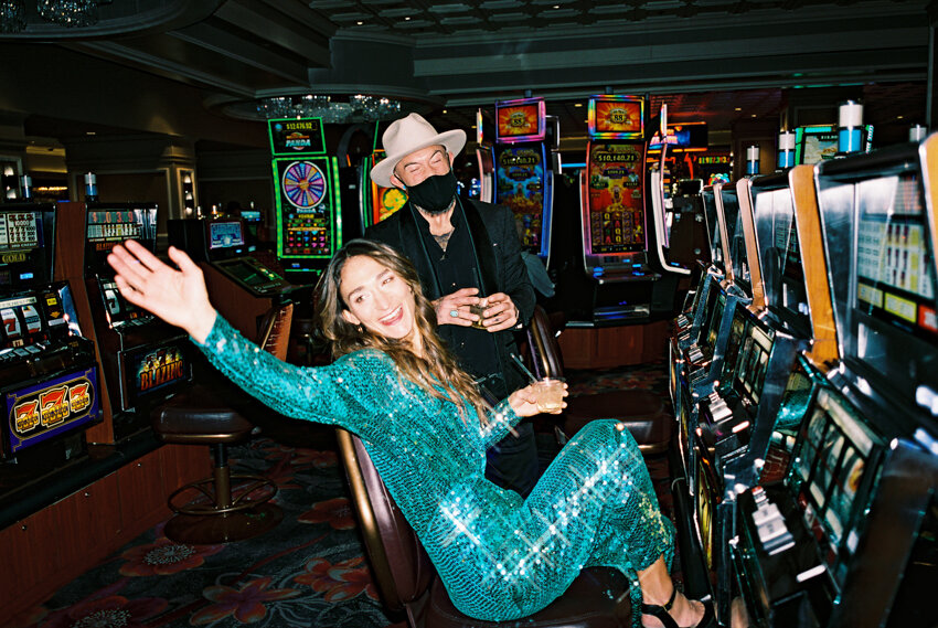 bride and groom gambling on slot machines