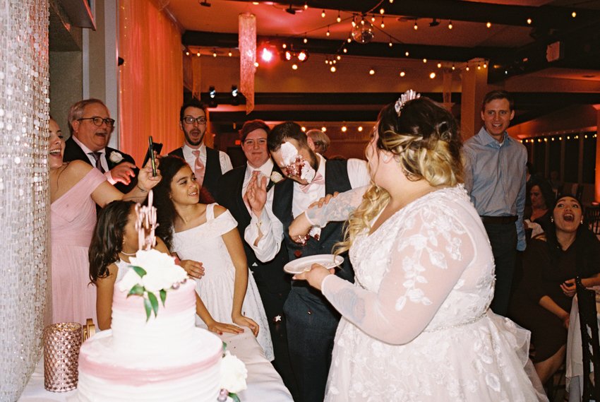 bride smashes cake on grooms face