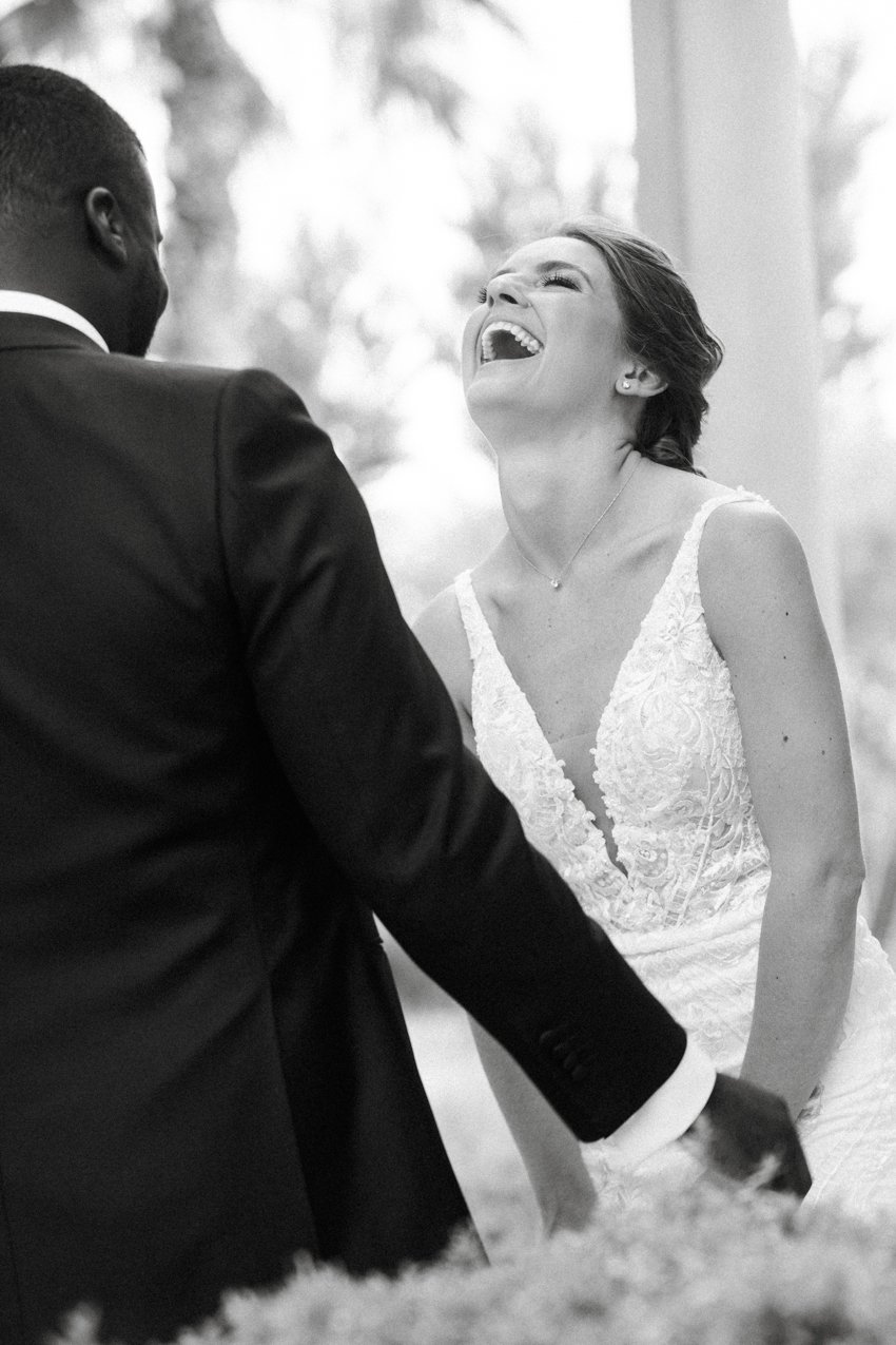 bride and groom first look laughing