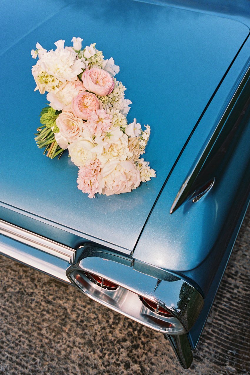 vintage blue cadillac wedding getaway car