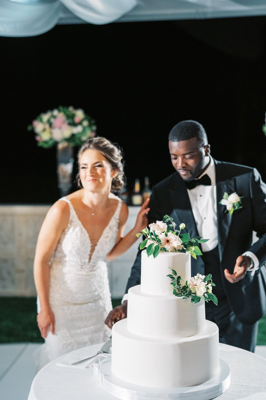 bride and groom cutting the cake