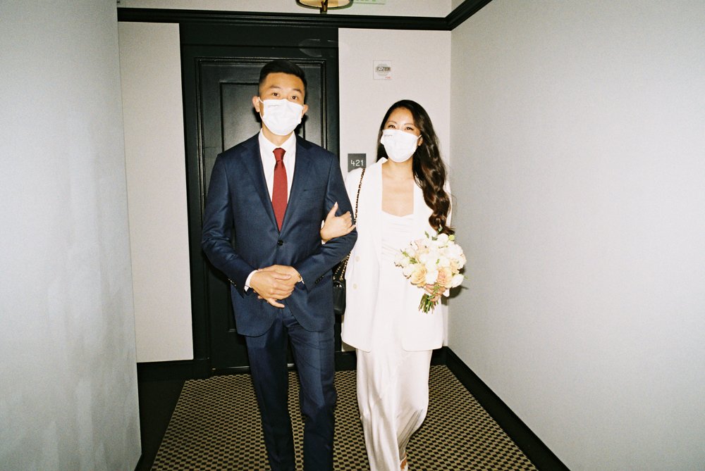 bride and groom wearing covid-19 masks