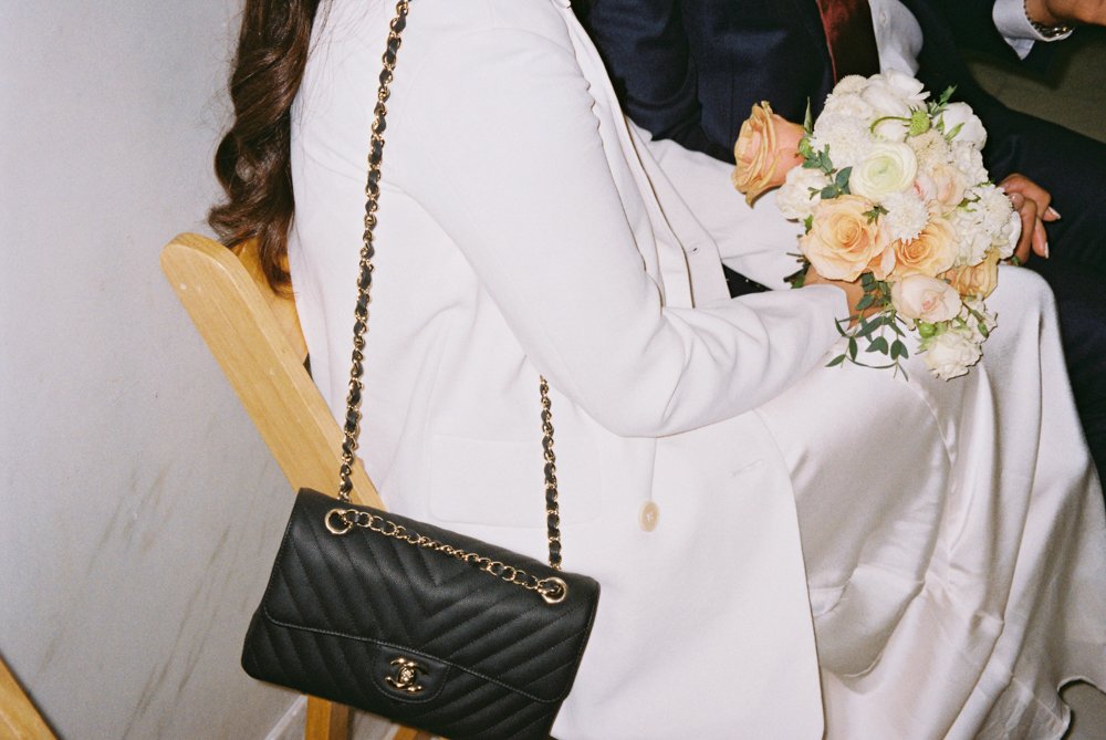 bride wearing black chanel bag