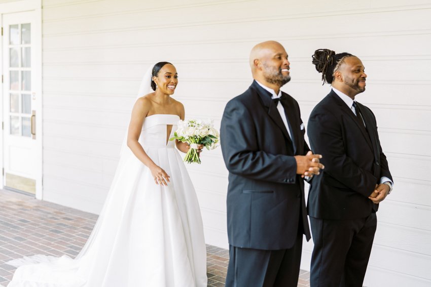 bride first look with dad and brother