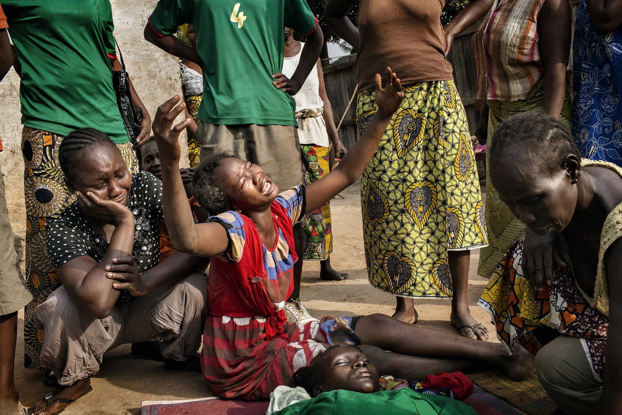 The sister of Vanessa mourns for her after she was shot by Muslims close to her home in Kilo 5 (a district of Bangui). Five people were killed overnight and just after this photograph was taken, her cousin was killed by Rwandan soldiers as he was killing a Muslim in a revenge attack.