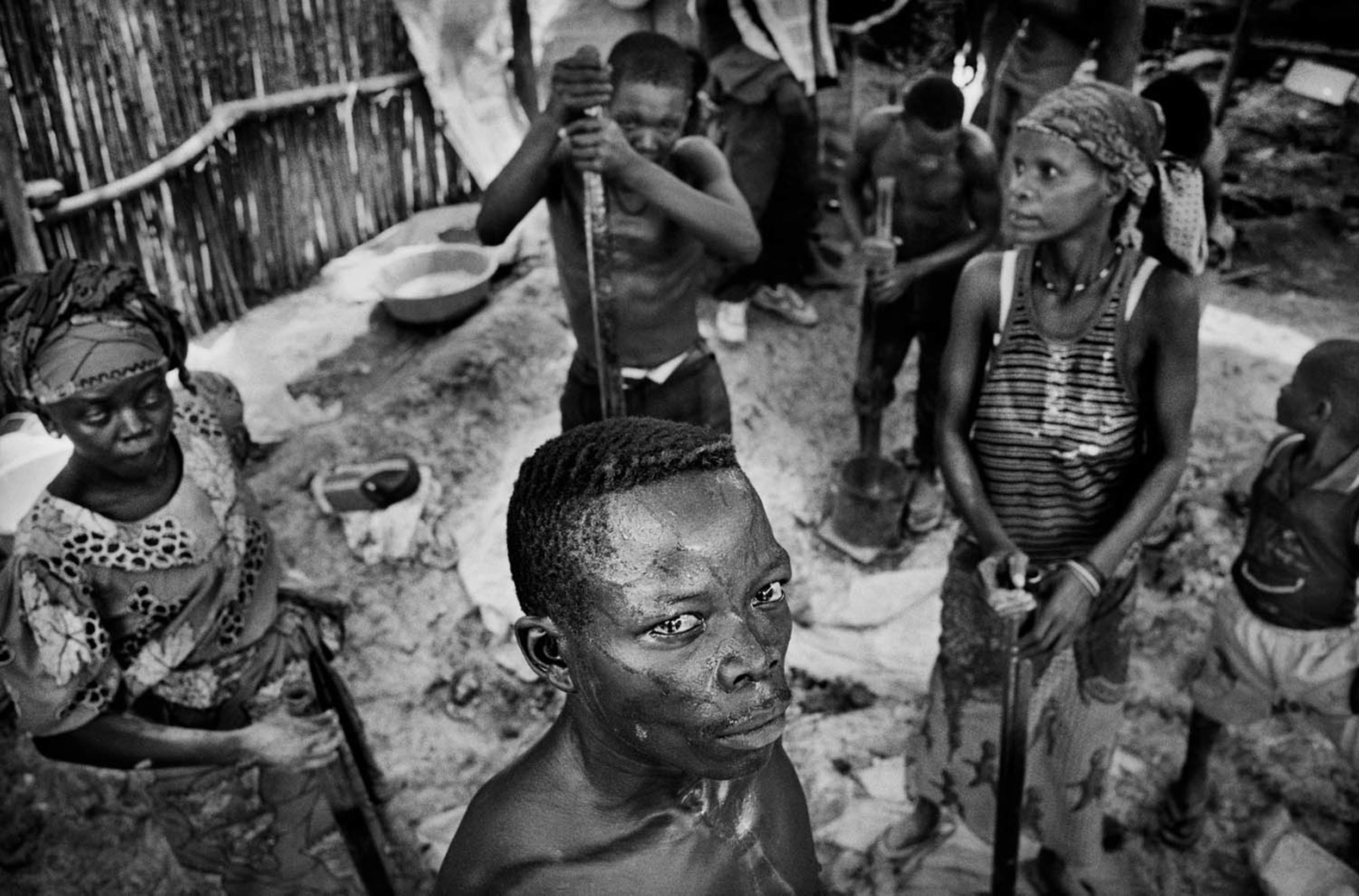 Bonded workers crush rocks in Mongbwalu, eastern Congo. Whole families work in slave conditions for warlords, controlling huge amounts of land, where gold is extracted to finance their military campaigns. 2004
