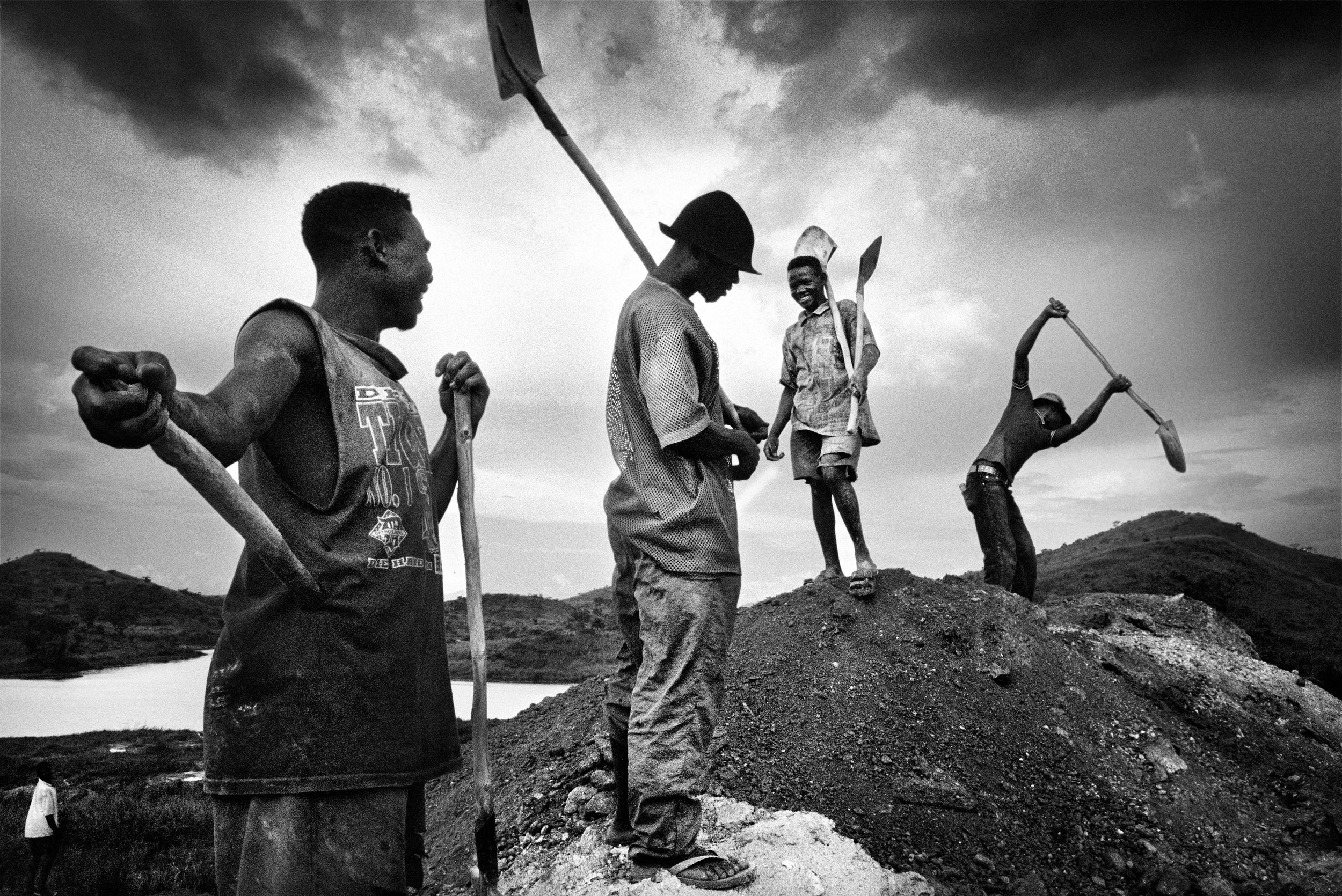 Gold miners pack up in the evening to return to their camp. 2004