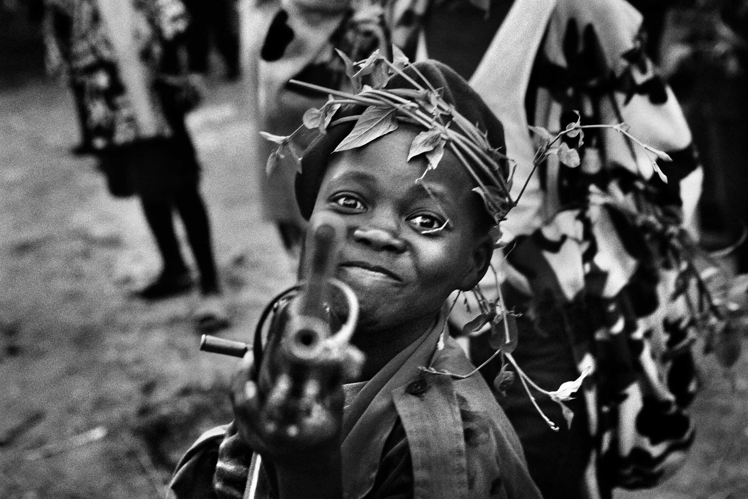 A child soldier with the Mayi-Mayi militia waits in Kanyabyonga as CNDP rebels advance. He was recruited while young men in the area were being abducted by the rebel forces. He didn’t want to be forced to fight, so he volunteered with the Mayi-Mayi.