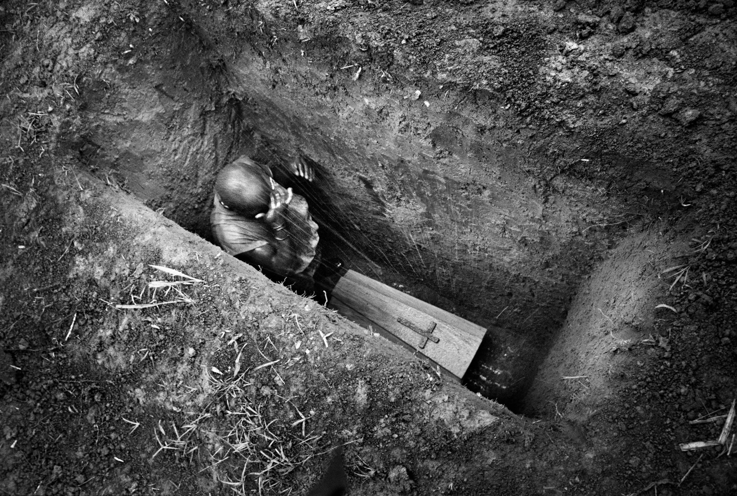 The burial of the eight-month-old Sakura Lisi, the daughter of a gold miner in Mongbwalu, northeastern Congo. 2004