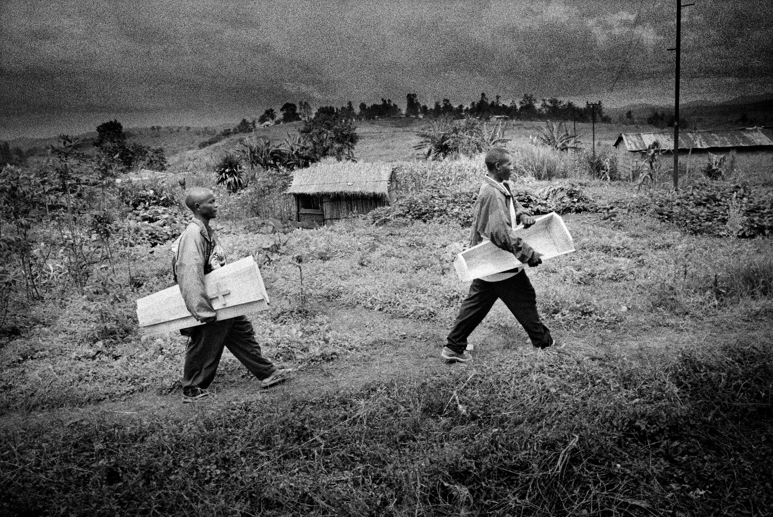 The coffin arrives for the burial of eight-month-old Sakura Lisi, the daughter of a gold miner in Mongbwalu, northeastern Congo. She died from anaemia brought on by malaria. 2004