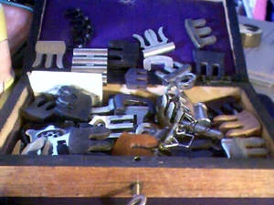 box of vintage violin mutes
