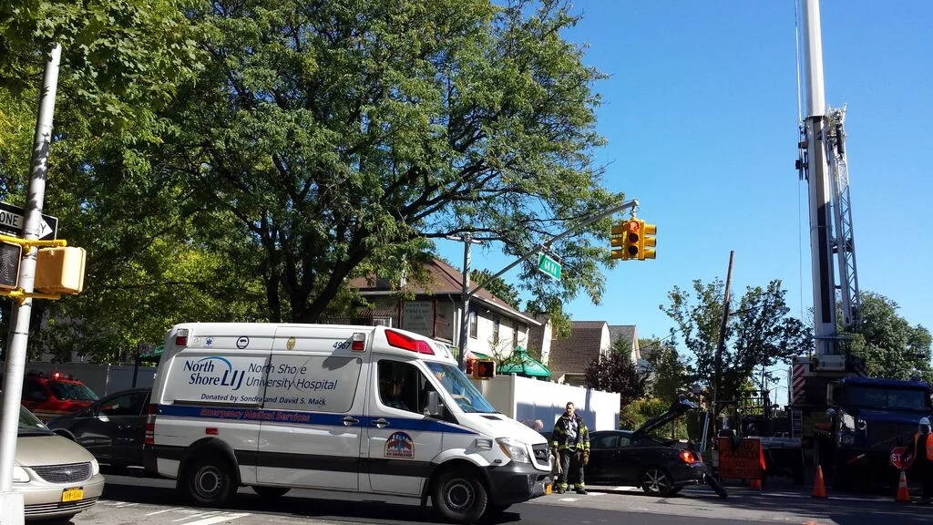 Our Neighbors' crane, an ambulance, a lady changing a flat tire, and the fire chief's SUV all make 108th St. Un-Navigable