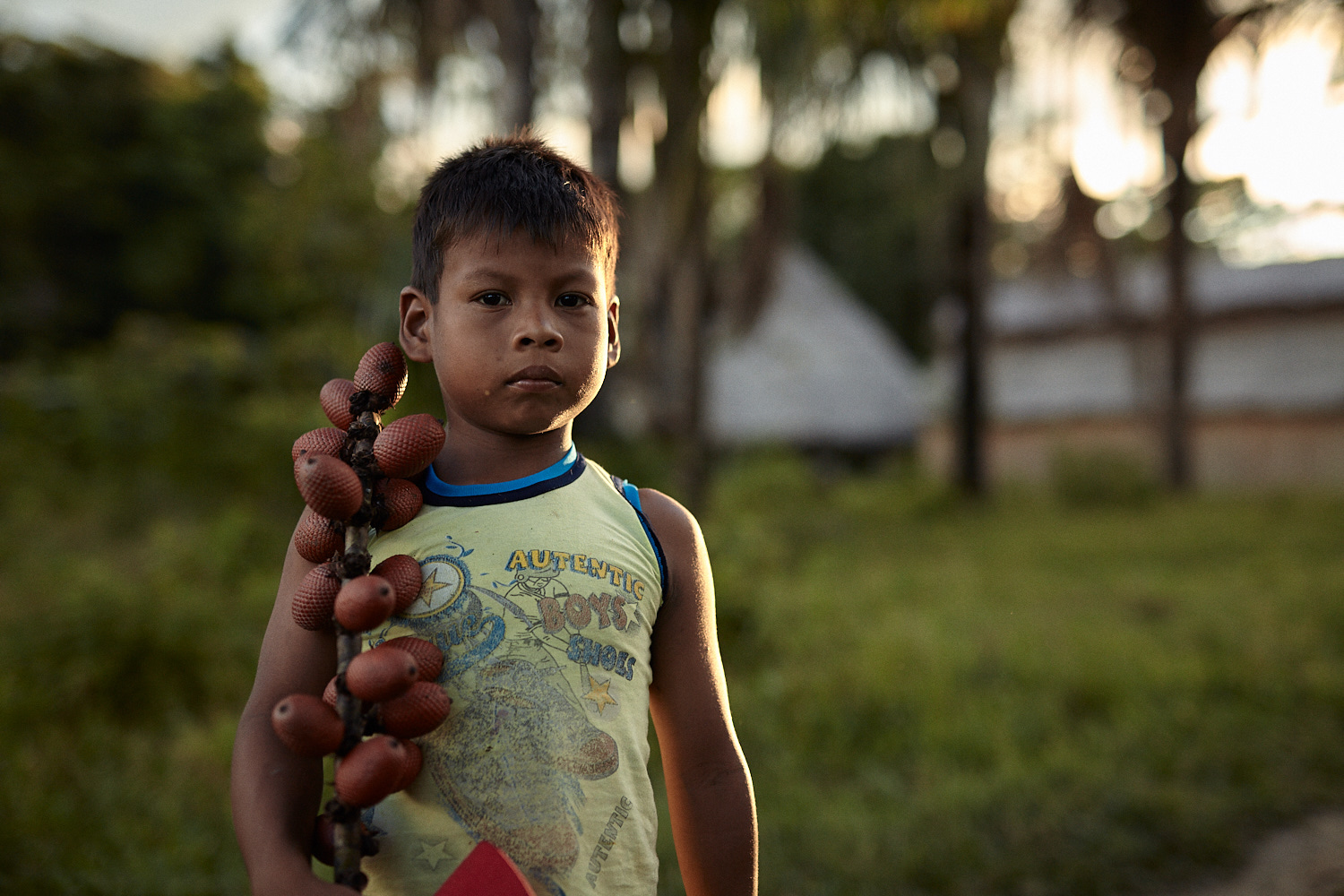  Langer, a five year old Maijuna boy holding fruits in the Peruvian Amazon 