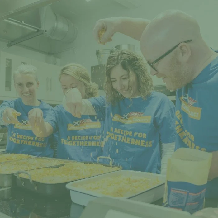 Scottish Chef, Gary Maclean and other people sprinkling cheese over a dish