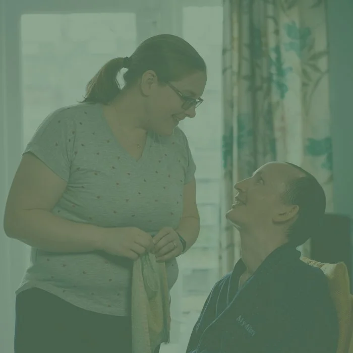 A couple looking at each other. The man has MND