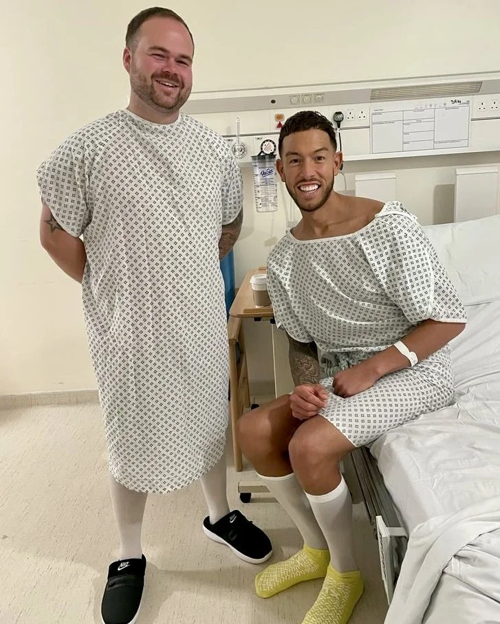 Two men in hospital gowns