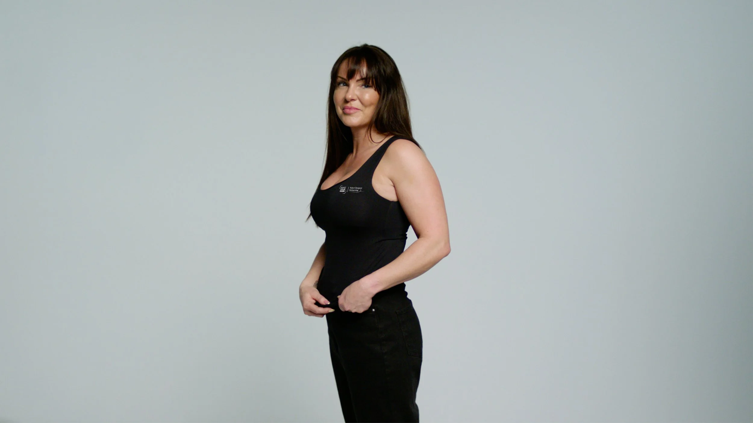 A woman standing in front of a screen