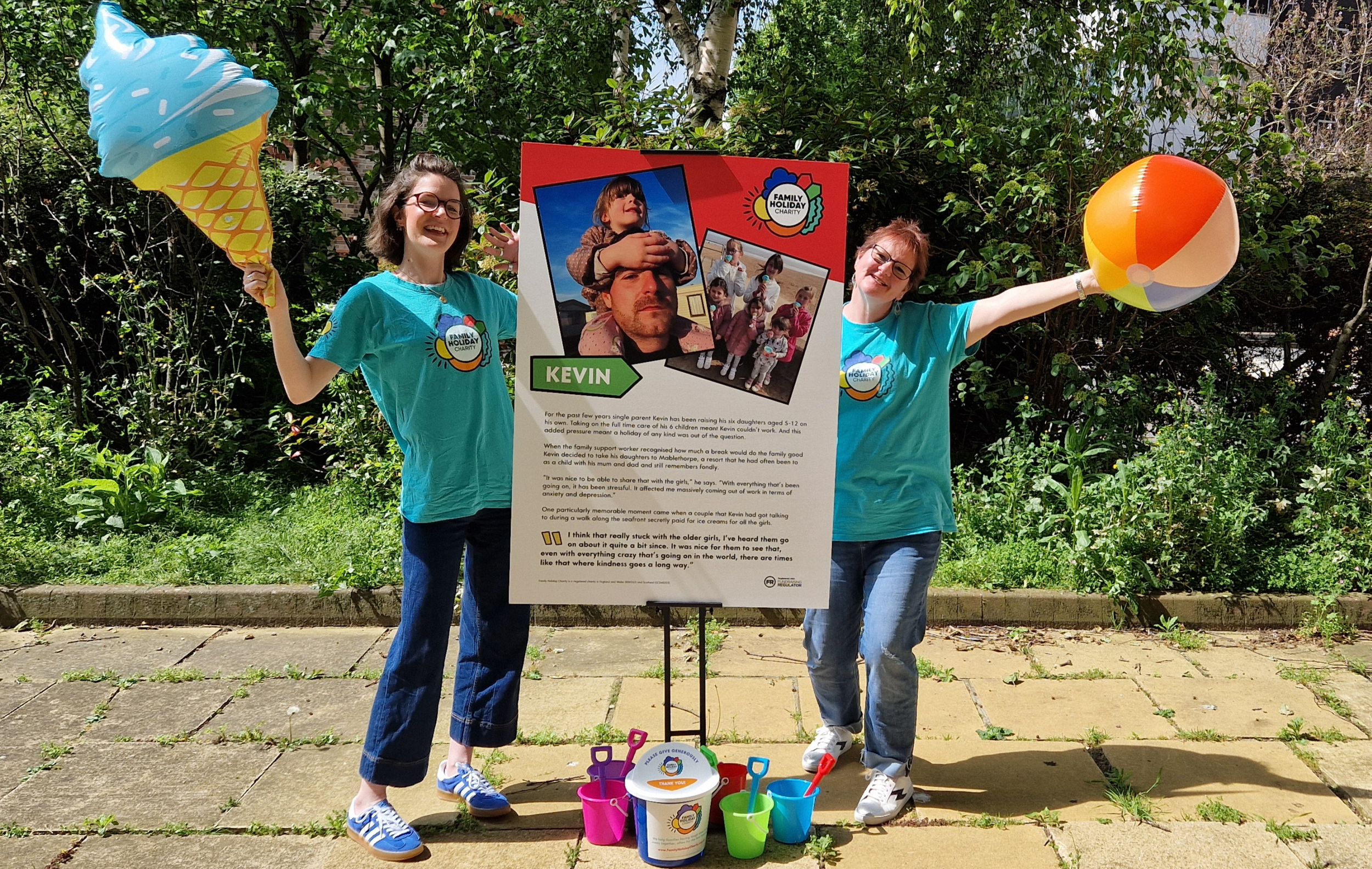 Image of two women by a pop up banner