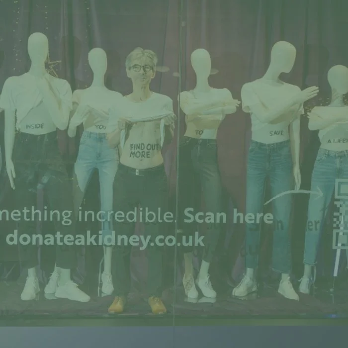 Kidney donor stood in a shop window