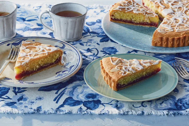 "The look was, as the British say, homely, but the textures, the tartness of the jam and the lovely, soft, slightly chewy and not very sweet cake made it the kind of dessert you come back to, finishing it sliver by sliver and dashing any hope you had of tucking some away for breakfast." (image via Gentl and Hyers for The New York Times. Food stylist: Maggie Ruggiero. Prop stylist: Rebecca Bartoshesky.)